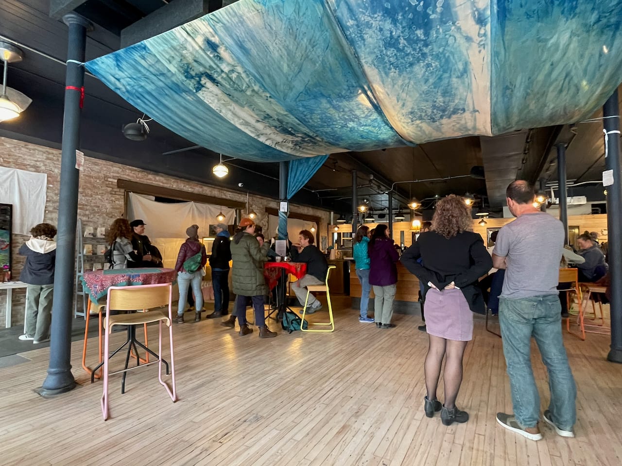 On a full night the room filled under Renée Greenlee’s cyanotype tapestry, from her Blue Alchemy series.
