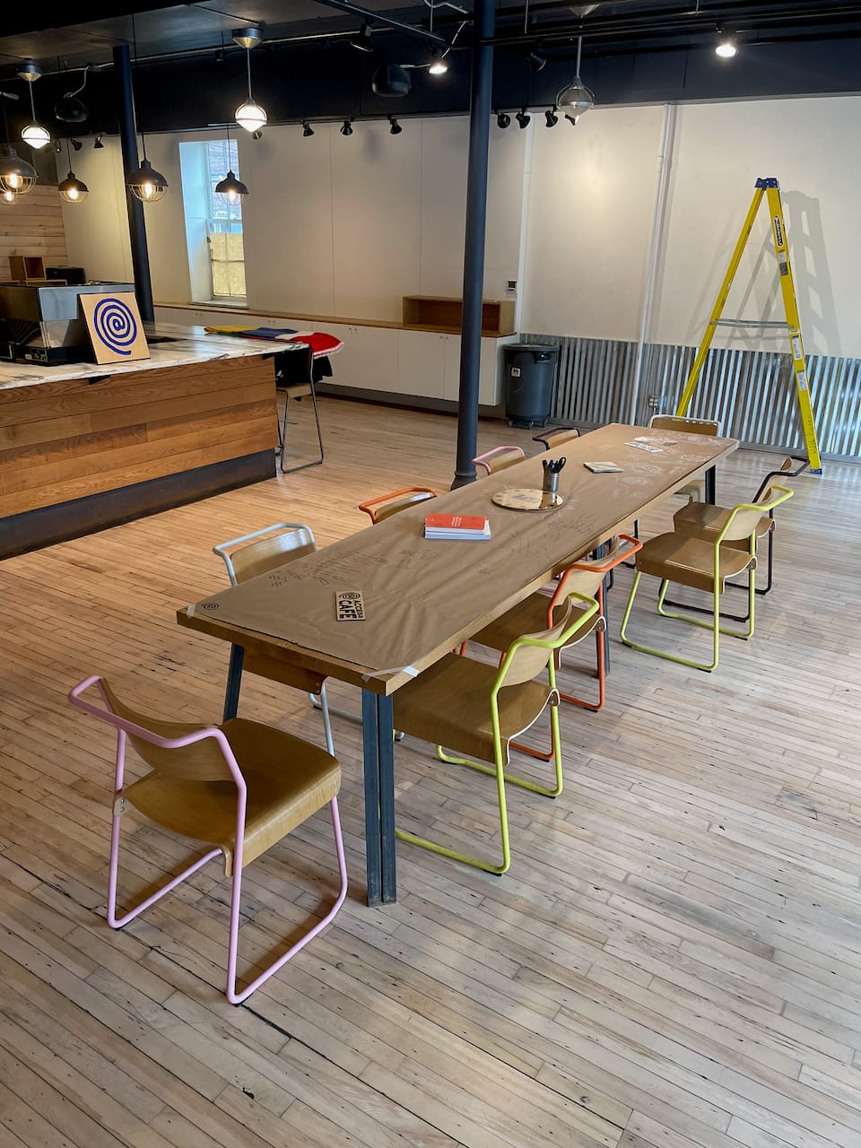 The buildout happened inside the room, starting with the long communal table at its center.