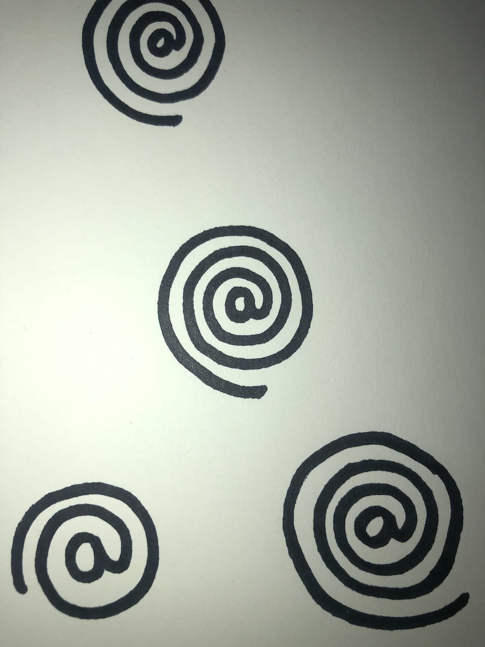 The café’s mark started as a drawing, a spiral wound into an @.