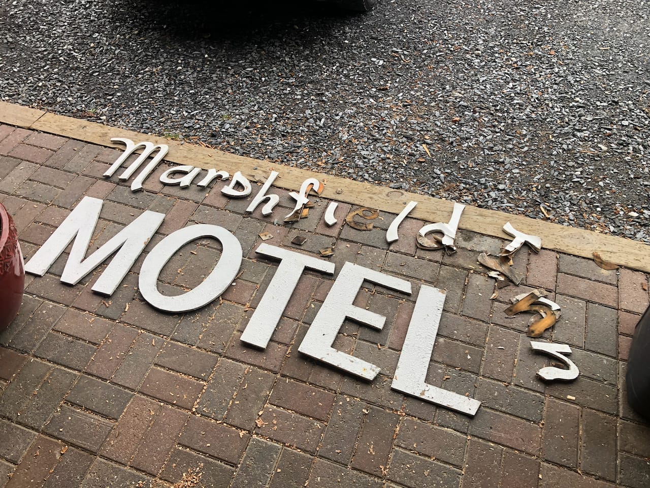 The letters pulled and laid out. MOTEL was intact; the script had rotted.