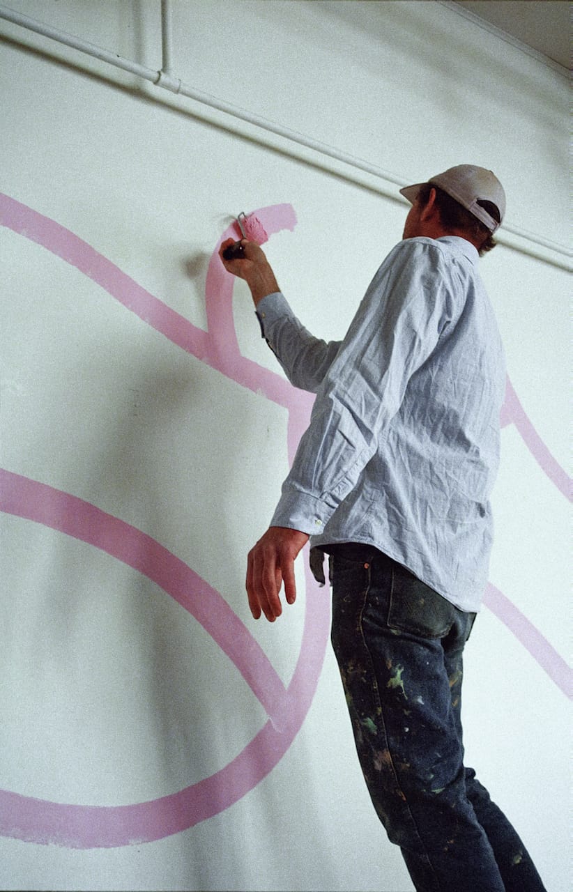 A mural going up in the Karma Bird House gallery.