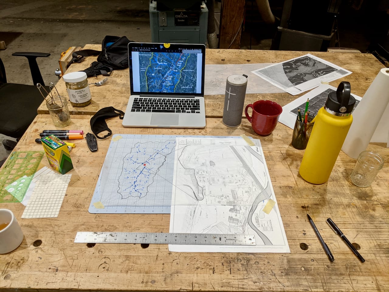 The design table, with hand-drawn site maps.