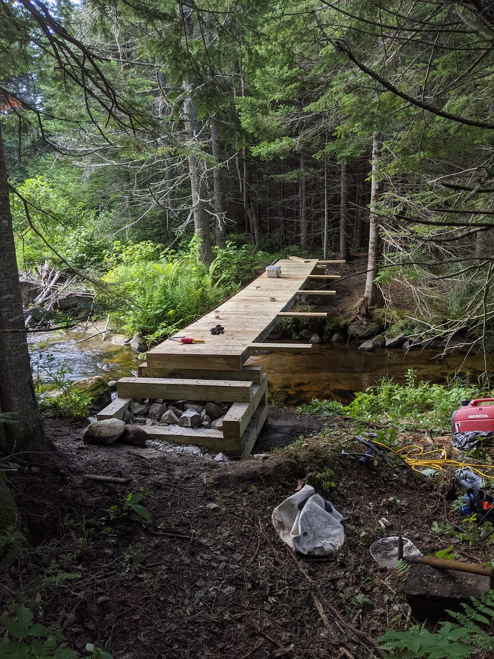 A low bridge over the water, with a stone-step landing.