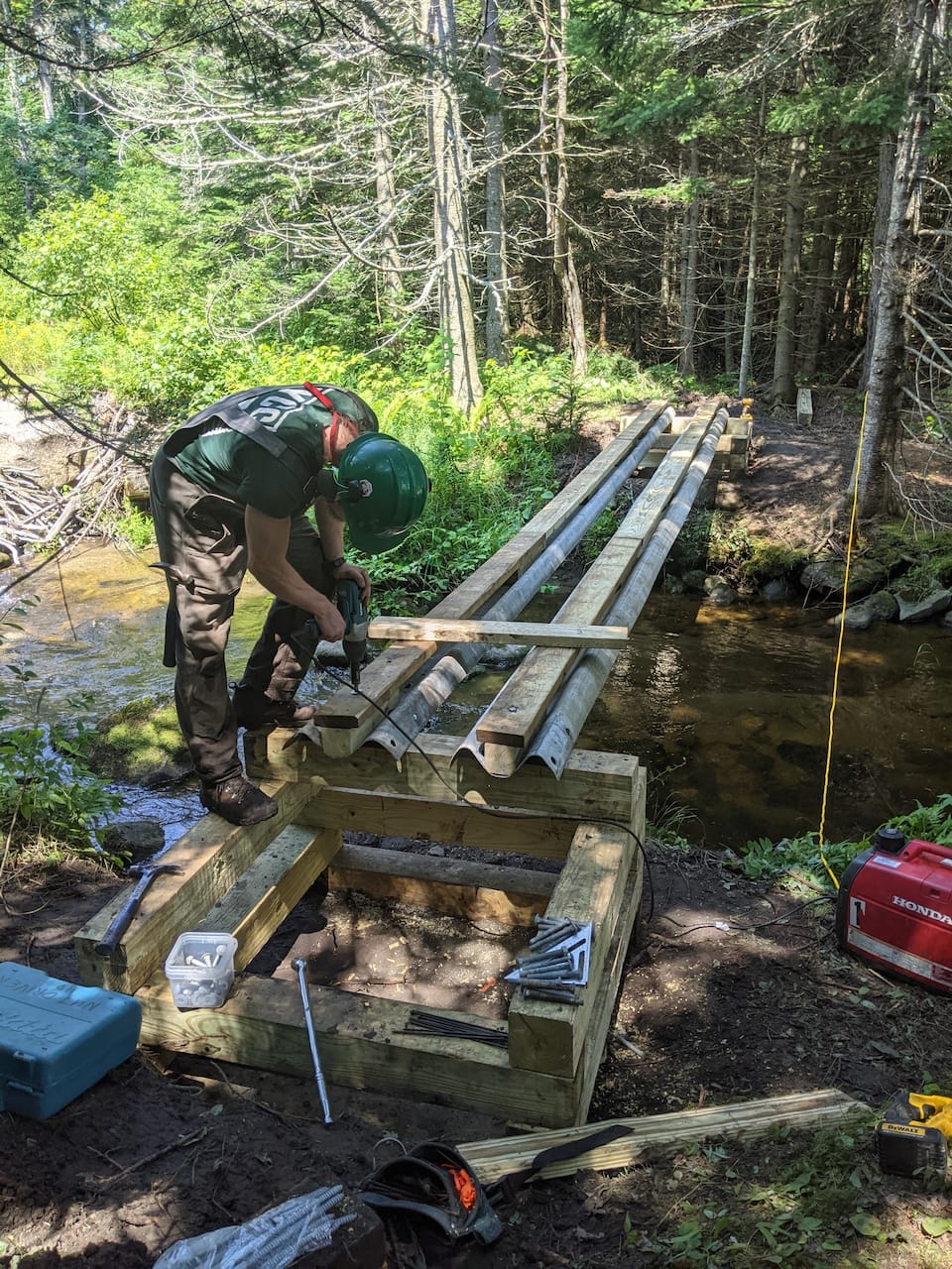 Framing a trail bridge on site.