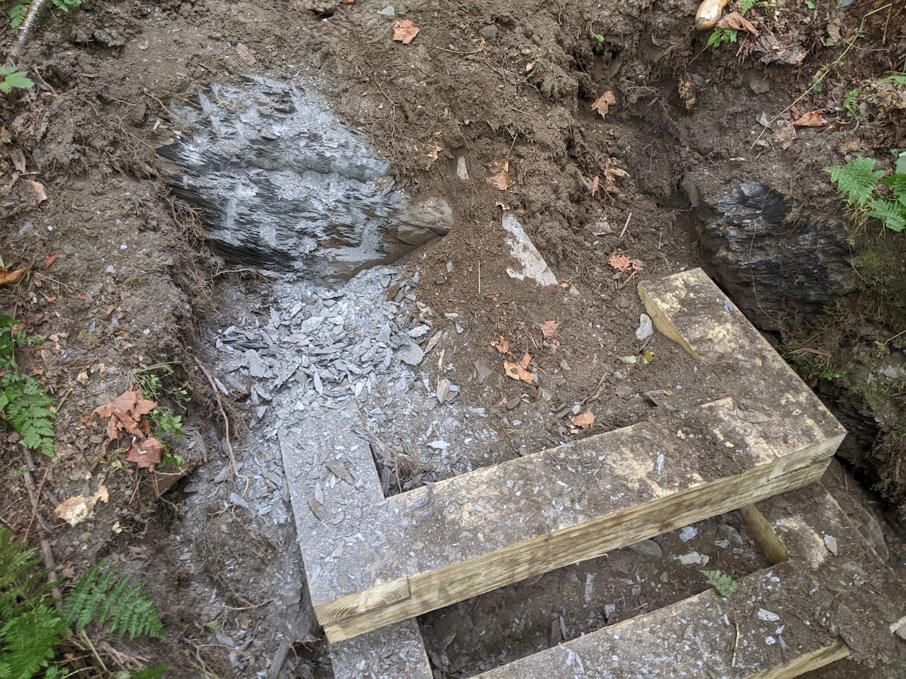 Wooden steps set into the rock ledge.